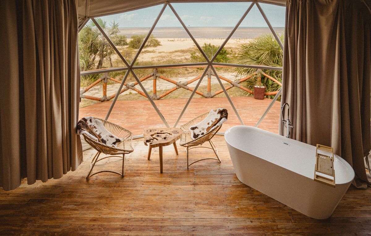 Inside a dome — Beds, headboards and the wood-and-canvas interiors of the domes, tent by tent.