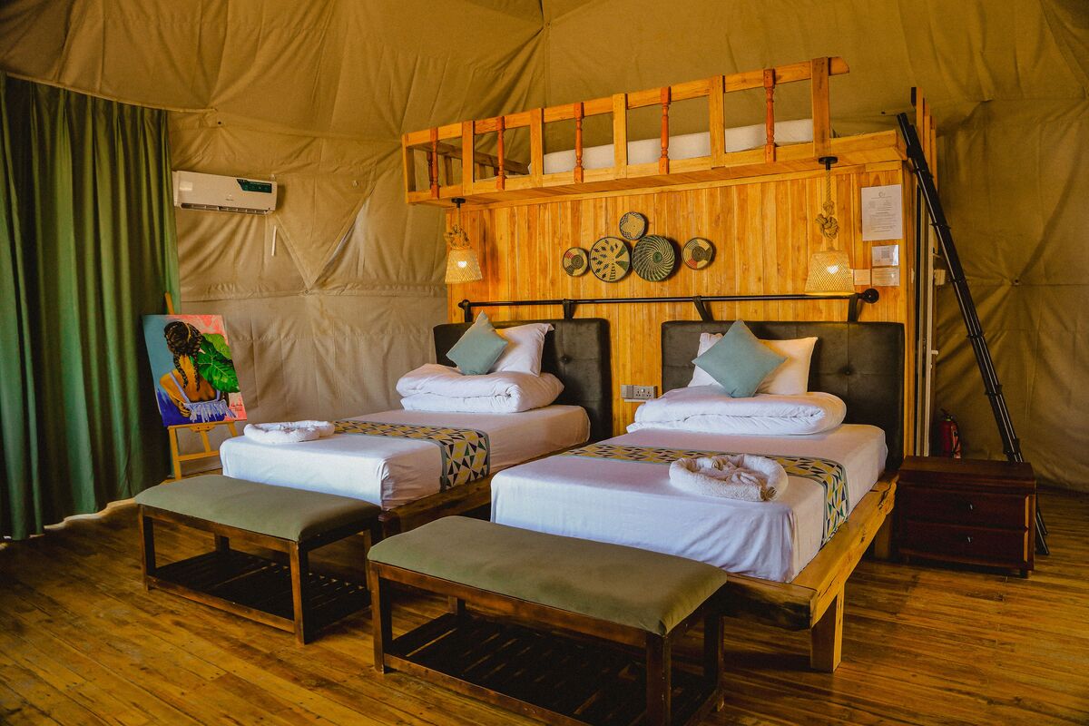Inside a dome — Beds, headboards and the wood-and-canvas interiors of the domes, tent by tent.