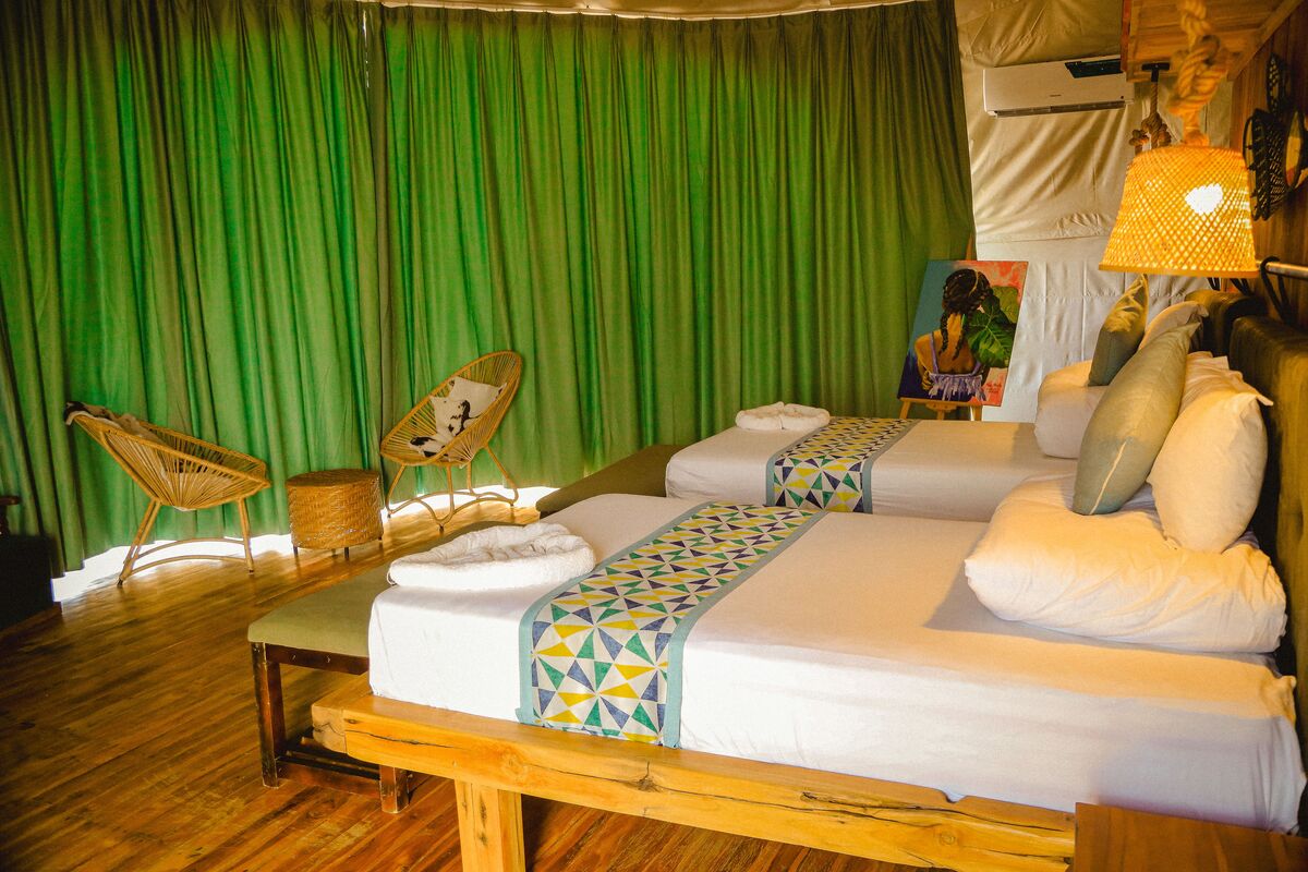 Inside a dome — Beds, headboards and the wood-and-canvas interiors of the domes, tent by tent.