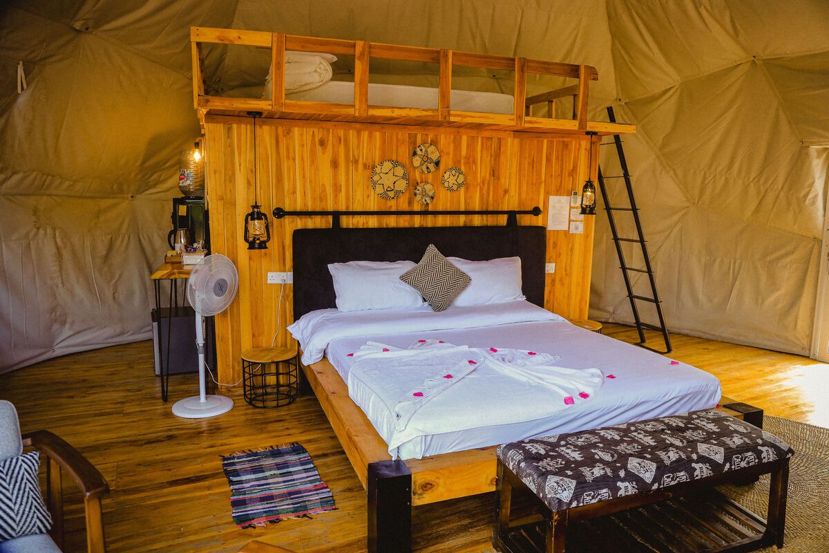 Inside a dome — Beds, headboards and the wood-and-canvas interiors of the domes, tent by tent.