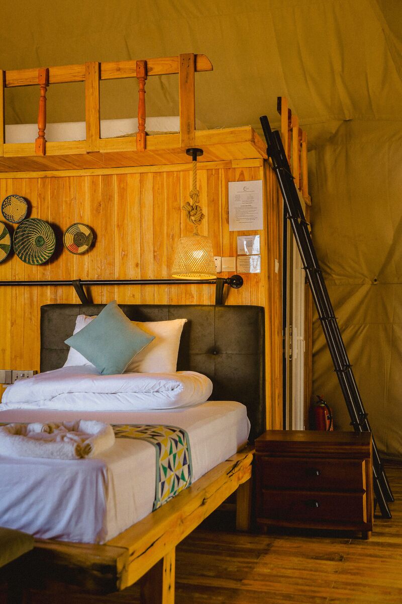 Inside the Twin dome at Cterra Saadani, with the separate beds and the woven plates on the timber wall