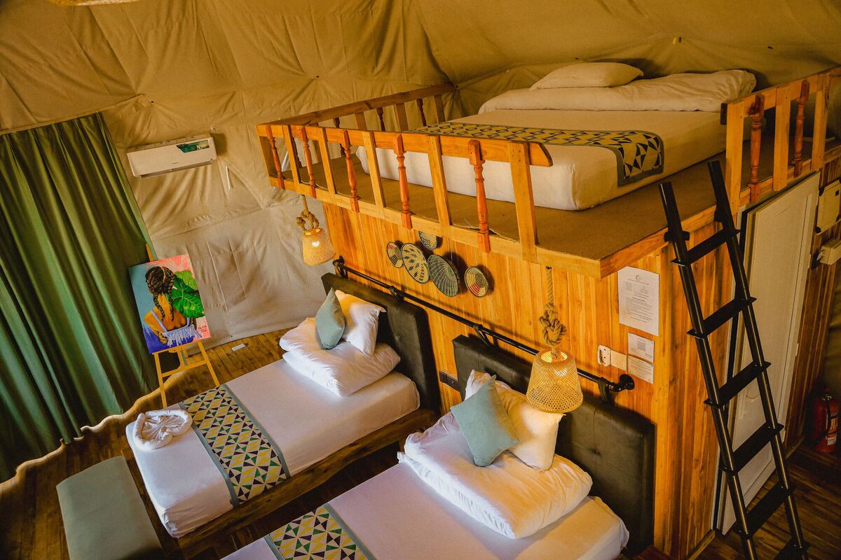 Inside the Twin dome at Cterra Saadani, with the separate beds and the woven plates on the timber wall